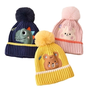 Cute knitted baby dinosaur hats with pompom available in navy, yellow and pink colors