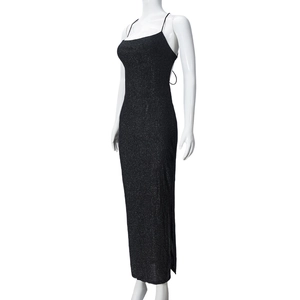 Detail of black glitter backless dress featuring thin cross straps and side slit design