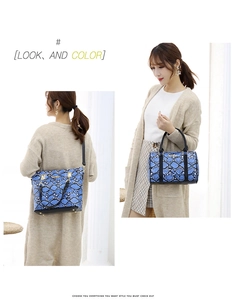 Blue snakeskin texture tote and bucket bag set styled by a model on white background