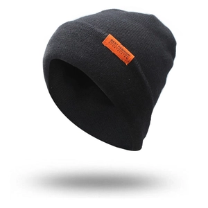 Detail of black knitted beanie with orange fashion label patch and textured stitching