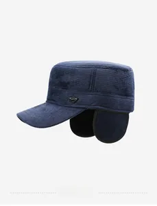 Detail view of winter flat top cap featuring navy textured fabric and fold-down ear flaps
