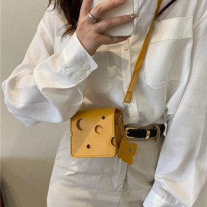 Mini yellow cheese-shaped crossbody bag with hollow design and cute matching charm