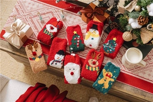 Detailed view of various Christmas coral fleece socks with festive reindeer and tree patterns