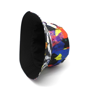 Detail of colorful graffiti print bucket hat with black and white checkerboard side stripes