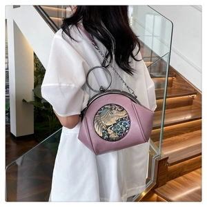 Detail of mauve shell bag with ornate elephant metal handle and vintage chain strap