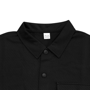 Close-up of black twill jacket detail showing lapel collar, button, and M size label