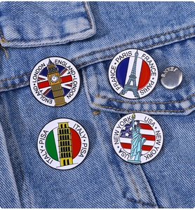 Detailed view of enamel pins featuring landmarks like Big Ben and Eiffel Tower on denim