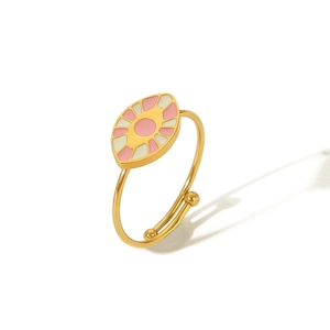 Detailed view of gold open ring with pink enamel eye motif and adjustable bead ends