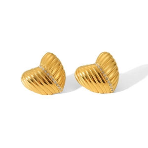 Detailed view of heart-shaped gold earrings with vertical texture and white rhinestones