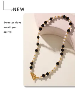 Detailed close-up of OT buckle necklace with black agate and white pearl beads