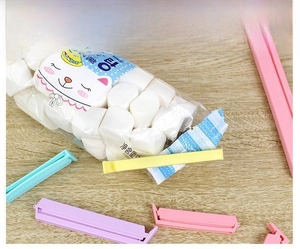Close-up of a colorful plastic sealing clip on a snack bag for moisture-proof storage