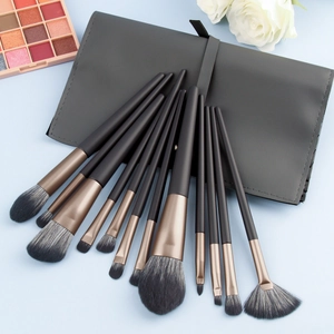 Professional 12-piece makeup brush set with champagne gold ferrules and gray storage bag