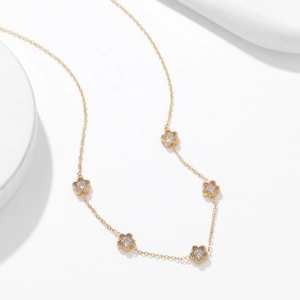 Elegant gold chain necklace featuring five pointed star charms with sparkling zircon stones
