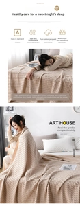 Detail of pure cotton waffle weave gauze blanket showing breathable soft texture in beige