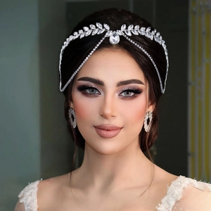 Detailed view of silver bridal headpiece and matching earrings with sparkling rhinestones