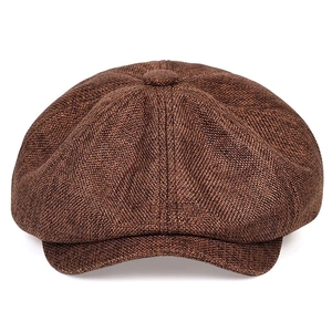 Detailed view of dark brown linen newsboy cap featuring coarse texture and top button