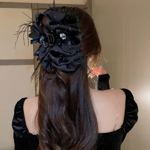 Large black satin floral hair claw clip with feathers and heart rhinestone for women