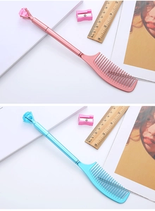 Close-up of cute pink and blue comb-shaped pens with large decorative diamonds on top