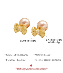 Detail view of bow earrings with cubic zirconia and champagne pearl in gold finish