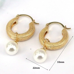 Detailed view of gold pearl earrings showing 22mm width and 33mm total height dimensions