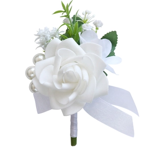 White silk rose boutonniere with decorative pearls and green leaves for outdoor weddings