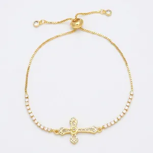 Adjustable gold cross bracelet with sparkling zircons and delicate tennis chain