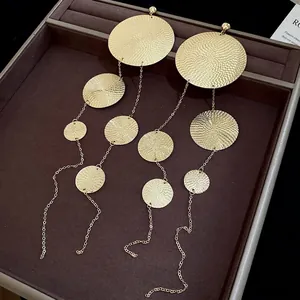Minimalist gold tiered circular tassel drop earrings with hammered metal texture
