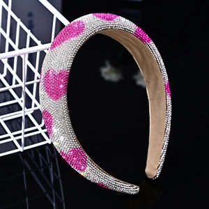 Detail of sponge headband with white rhinestones and pink heart-shaped crystal patterns