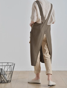 Detail view of washed linen apron showing the back cross straps and elegant drape