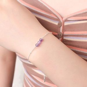Detail of beaded natural amethyst bracelet on wrist with 925 silver plated finish