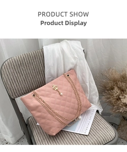 Close-up of pink quilted tote bag with golden crown pearl pendant and chain strap
