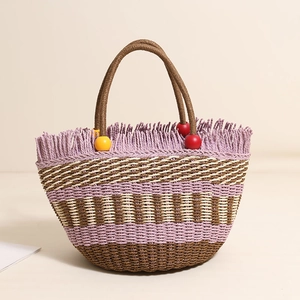 Handmade woven straw bucket bag with purple stripes, fringe edge, and wooden beads handle