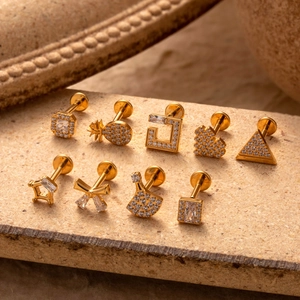 Nine assorted G23 titanium labret studs with gold finish and inlaid zircon stones