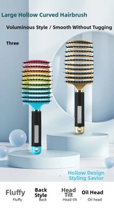 Close-up of curved vented hairbrushes with boar bristles and non-slip handles on a tray