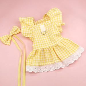 Detail of yellow plaid pet dress with white lace hem and metal D-ring for leash attachment
