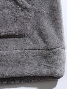 Macro close-up of thick grey flannel fleece texture on men's hoodie pocket and hem