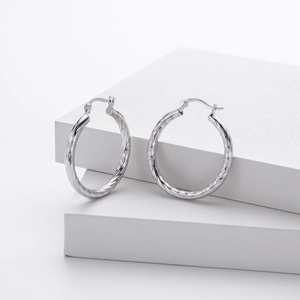 Detail showing the S925 hallmark on polished silver twisted rope hoop earrings