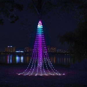 Outdoor RGB LED waterfall lights with star topper hanging by a lake at night