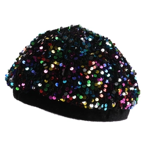 Close-up detail of colorful sequins and black velvet trim on a stylish beret hat
