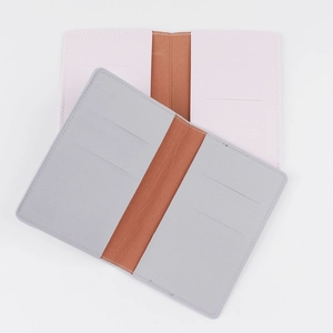 Detailed view of the fine PU leather texture and stitching on pink and gray passport covers