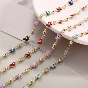 Detailed close-up of colorful enamel butterfly pendants on gold stainless steel necklaces