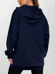 Rear view of a navy blue oversized hoodie featuring a minimalist loose fit and hood detail