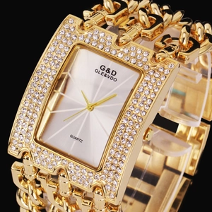 Detailed macro view of golden square quartz watch with crystal-encrusted bezel and chain strap
