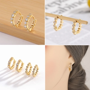 Detalle de pendientes de aro bañados en oro 18K con pavé de circonitas en dos tamaños
