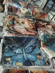 Detail of bulk canvas tote bags with 3D butterfly embroidery in protective polybags