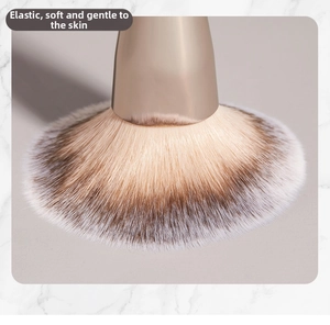 Macro detail of soft synthetic makeup brush bristles with a brown and white gradient finish