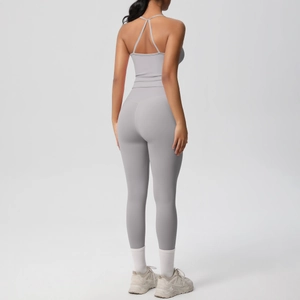 Detail of cross-back yoga top and high-waist leggings in grey high-stretch fabric