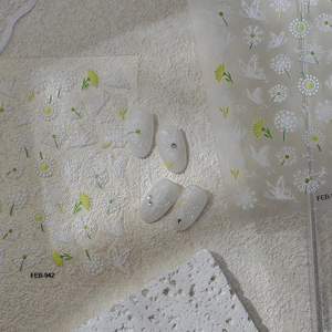 Detailed view of 5D embossed nail stickers featuring dandelion and butterfly patterns