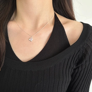 Minimalist s925 silver star necklace with pink zircon pendant worn on a female model