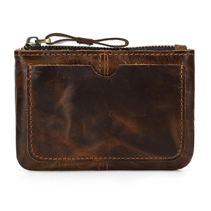 Detail of dark brown vintage cowhide leather coin purse with stitching and metal zipper